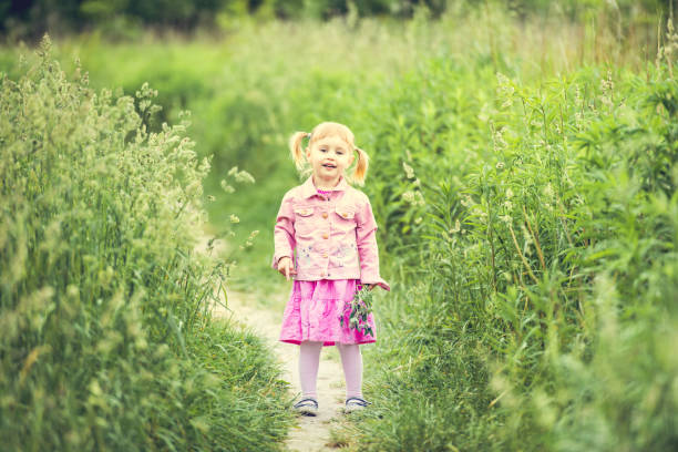 istock Cute little girl on the meadow 1432005307