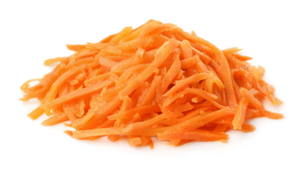 Pile of pickled grated carrot Pile of pickled grated carrot isolated on white pile of carrots stock pictures, royalty-free photos & images