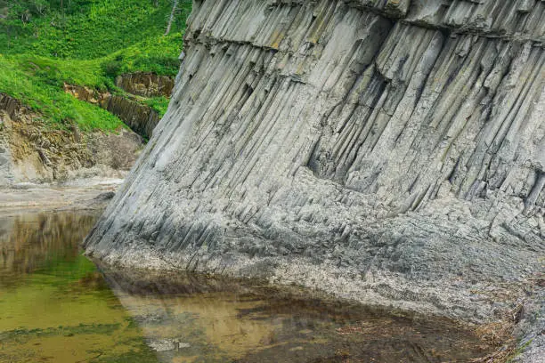 foot of a coastal cliff composed of columnar basalt, on the island of Kunashir