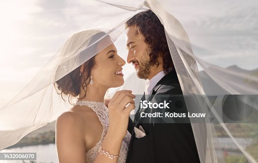 istock Couple, love or wedding dress veil after marriage event, ceremony or union in nature environment. Smile, happy or trust man or woman or bride and groom bonding after romance celebration by water lake 1432006070