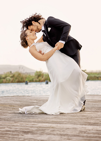 bride and groom are hugging on the rocky beach of the Mamula island. High quality photo