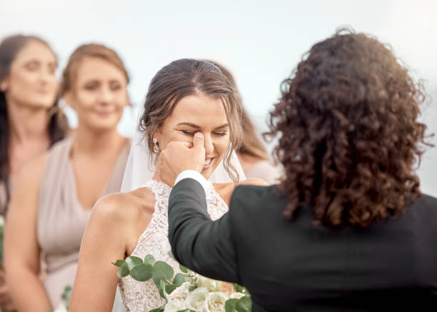 istock Wedding, happy and love with couple crying at event with friends for commitment, celebration or joy. Support, trust or hope with man cleaning tears of woman at marriage ceremony for faith and romance 1432007069