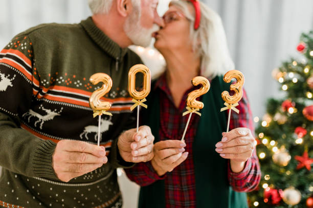 istock Senior couple holding numbers 2023 while celebrating New Year 1432008562