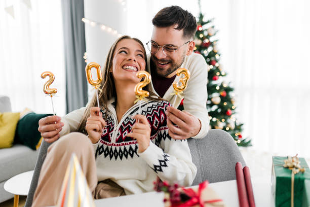 istock Couple holding numbers 2023 while celebrating New Year 1432008972