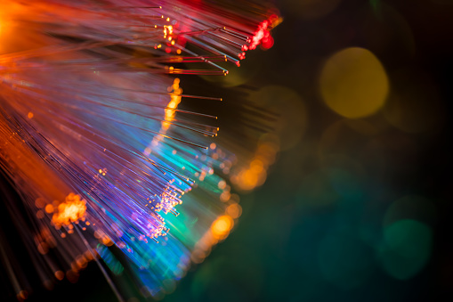 A DSLR close-up photo of fiber optics on a dark background. Beautiful bokeh.