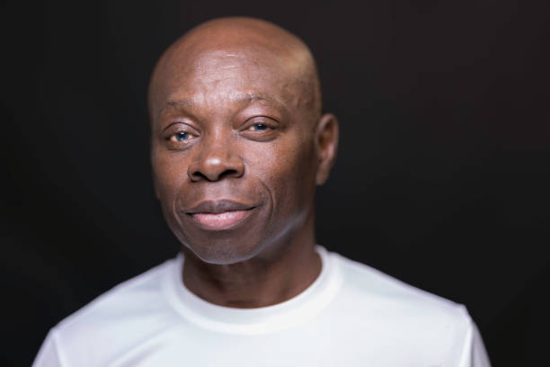 Senior Afro-Caribbean man wearing a white t-shirt.