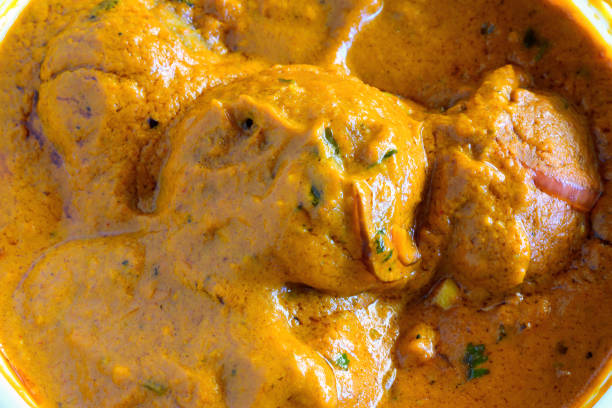 Closeup of Malai Kofta-a traditional North Indian vegetarian dish with round deep fried dumplings of minced vegetables, raisins, potato and cottage cheese in a thick rich gravy with cashew nut paste.