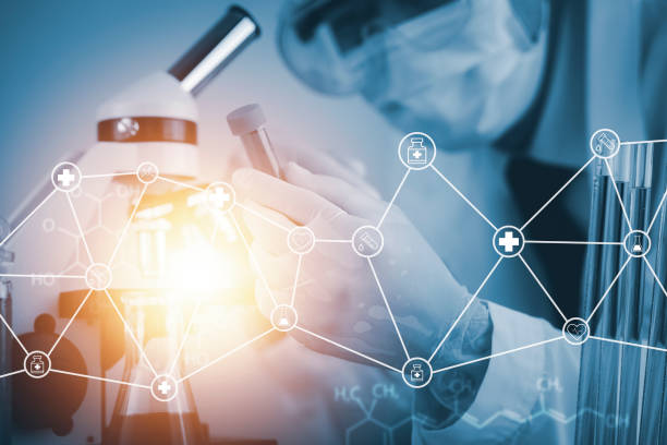 istock biochemical research scientist working with a microscope for the virus,Doctor man write a history of the experimental results in a , laboratory glassware containing chemical liquid for design. 1432010811