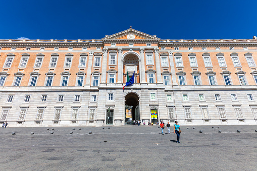 Caserta, Italy. October 29, 2017: The Royal Palace of Caserta (Italian: Reggia di Caserta). Former royal residence in Caserta, southern Italy, constructed for the Bourbon kings of Naples. Some tourists visiting.