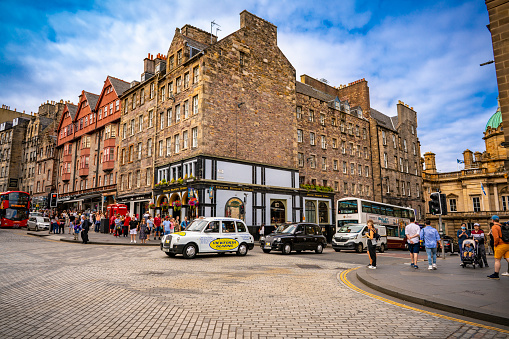 Edinburgh The Royal Mile capital city of Scotland UK United Kingdom. Several streets considered as the main thoroughfare of the Old Town. On mile long, is the busiest tourist street in the Old Town. Runs from Edinburgh Castle to Holyrood Palace