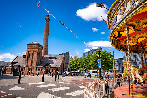 Liverpool Royal Albert Dock Victorian Carousel and Pump House in England UK United Kingdom. The Dock's former pumphouse built in 1870, has been restored to a public house