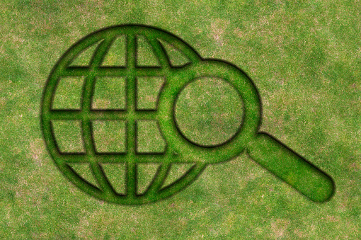 Magnifying Glass Made Of Green Grass : Environmental Issues And Green Energy Concept