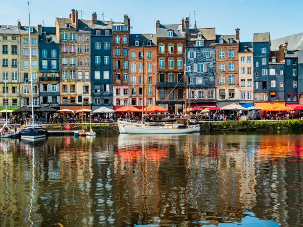 Impressive view of Honfleur waterfront with colorful houses reflected in the harbor, Normandy, France