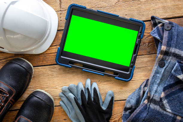 istock Builder uniform and digital tablet on wooden background, flat lay. 1432016588