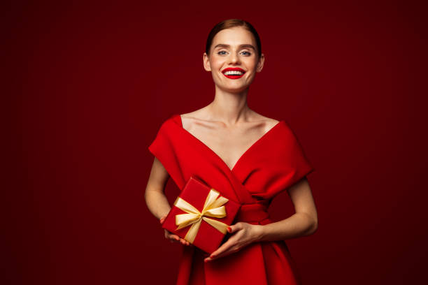 istock Beautiful emotional woman holding present box 1432018386