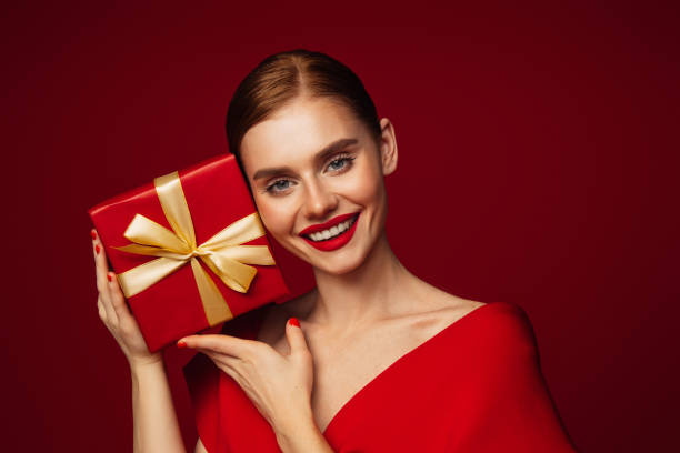 istock Beautiful emotional woman holding present box 1432018408