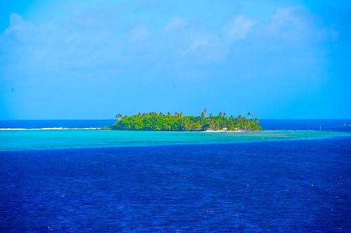 Idyllic tropical beach vacation with blue sky and palm trees. Tranquil Rangaroa, French Polynesian