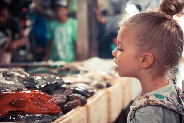 Photo of Choosing raw fish on seafood market on fish marker