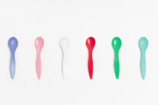 Photo of Spoons White background green, red, pink, white, violet