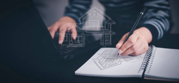 istock Engineering and architecture drawings and mini home model concept, Engineer man writing of architect starting draw a house blueprint on the desk in the home office, work from home, Real estate offer 1432019250