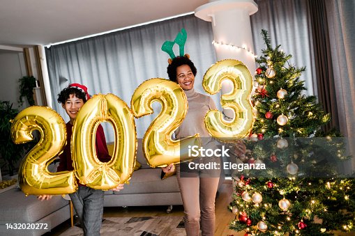istock Mother and son  holding golden balloons shaped as numbers 2022, representing the upcoming New Year 1432020272