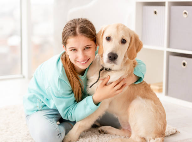 istock Cute girl hugging dog 1432022785