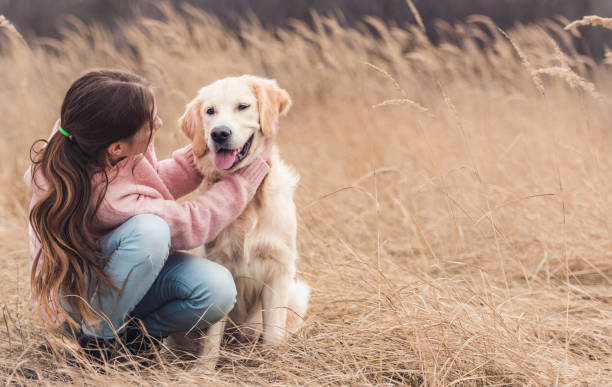 istock Happy girl petting young dog 1432022853