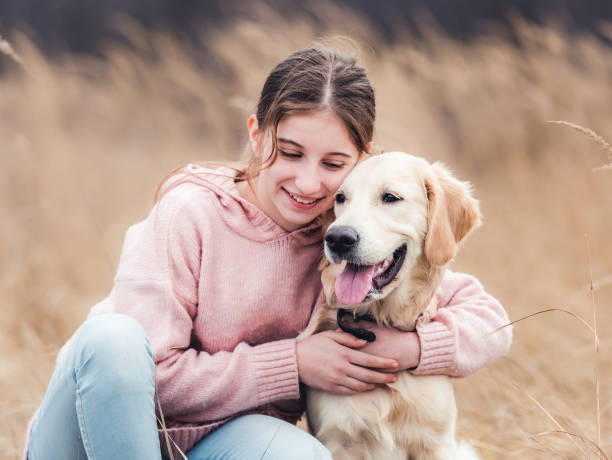 istock Cute girl hugging golden retriever 1432022854