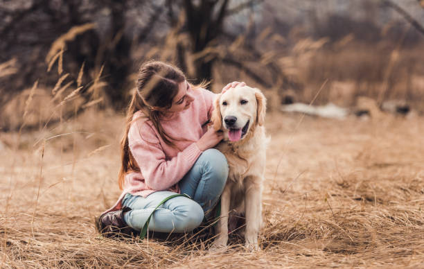 istock Beautiful girl with dog outside 1432022863