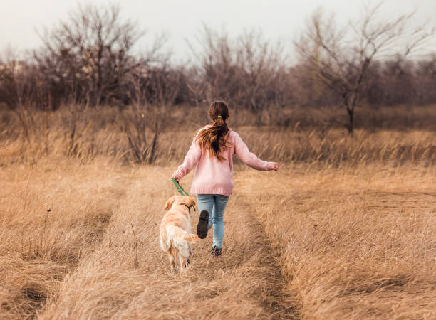 istock Cheerful girl with active dog 1432022868