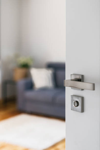 istock opened white door and view at living room interior 1432024060