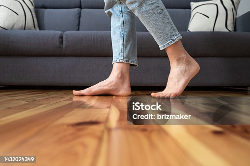 istock cropped shot of woman walking barefoot in room 1432024349
