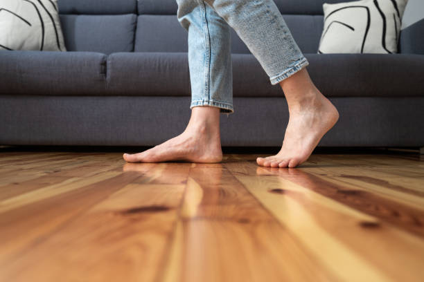 cropped shot of woman walking barefoot in room stock photo