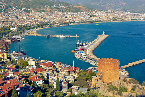 Beautiful view of Alanya Harbor, Red Tower and stone wall of Alanya Castle. Antalya Province, Turkey