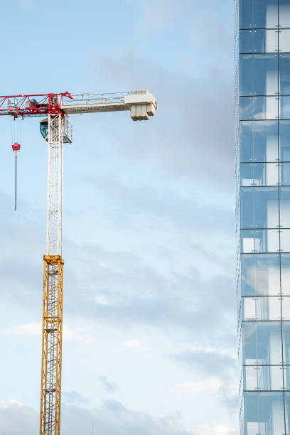 istock Tower crane with a glass wall of the skyscraper 1432024817