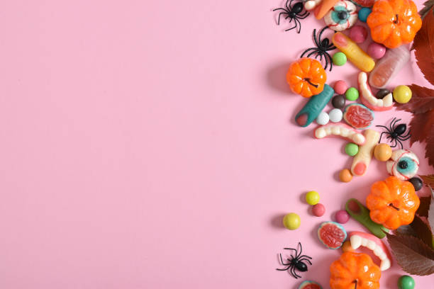 istock Various sweets on a pink background. Happy Halloween. Copy space. Flat lay, top view 1432025535