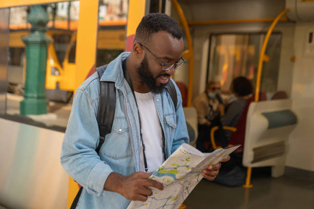 istock Young adult man with map at terminal train station 1432033090