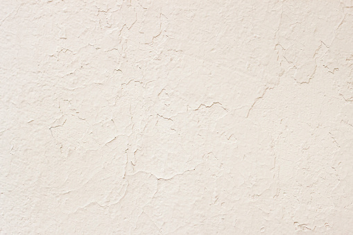 Old painted plaster cream wall, concrete texture. Abstract pastel background
