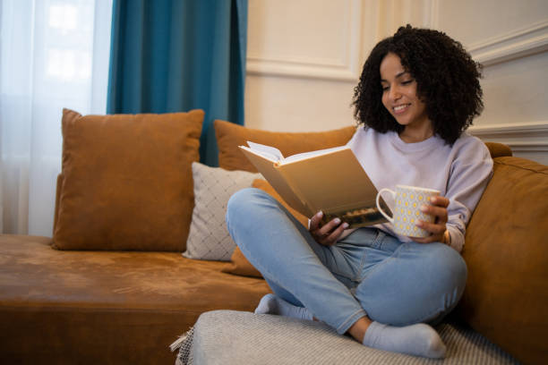 istock Woman relaxing and reading a book 1432034431