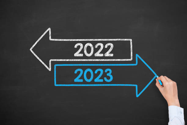 istock Human Hand Drawing Old Year or New Year 2023 on Chalkboard Background 1432035785