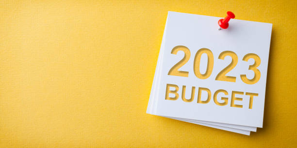 istock Budget 2023 Word in White Sticky Note on Yellow Chardboard Background 1432035887