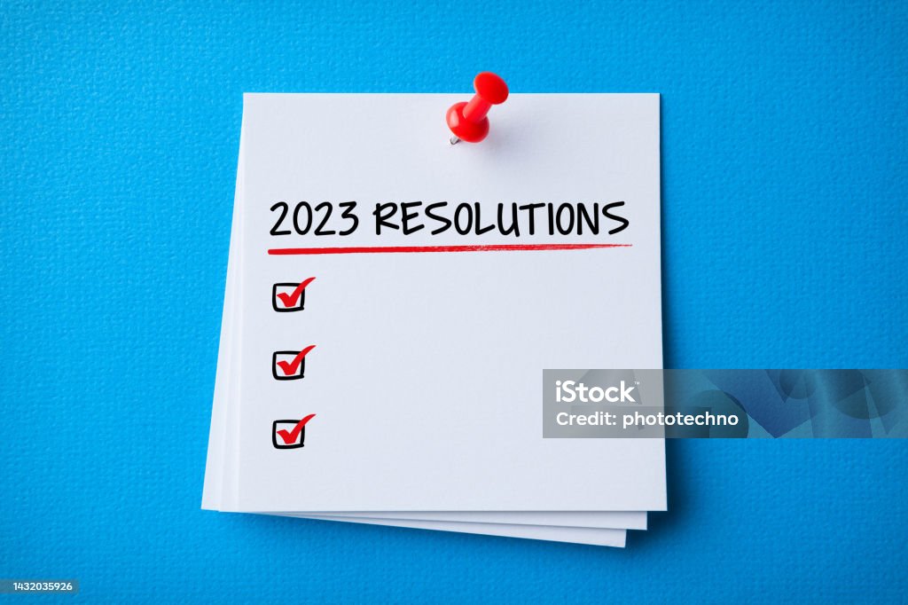 White Sticky Note With New Year 2023 Resolutions And Red Push Pin On Blue Cardboard Background 2023 Stock Photo
