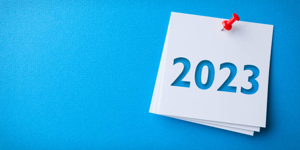 istock White Sticky Note With Happy New Year 2023 And Red Push Pin On Blue Cardboard Background 1432035927
