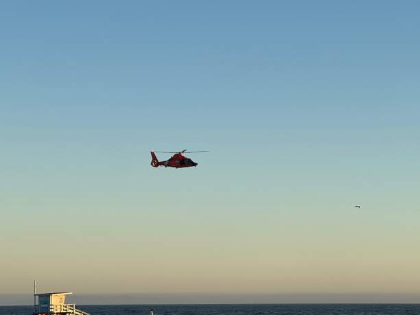 istock Coast Guard helicopter flying over Venice Beach in the sunset 1432036790