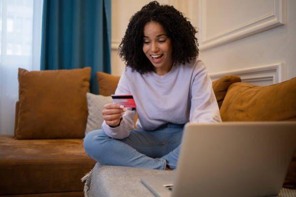 istock Woman using her credit card to shop online 1432046061