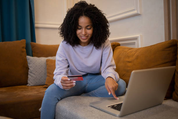 istock Woman using her credit card to shop online 1432046062