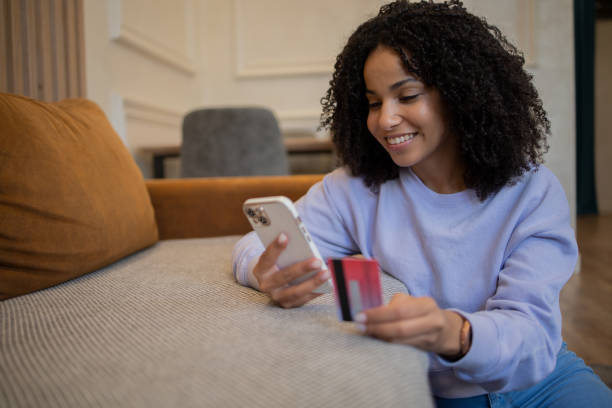istock Woman using her credit card to shop online 1432046097