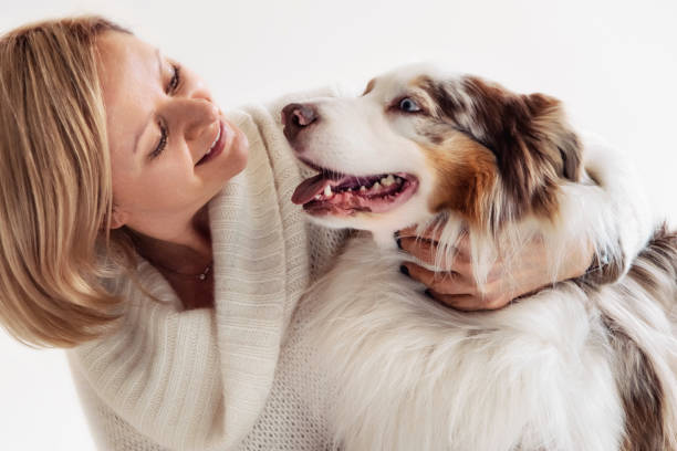 istock Woman and Australian Shepherd Dog having fun 1432046810