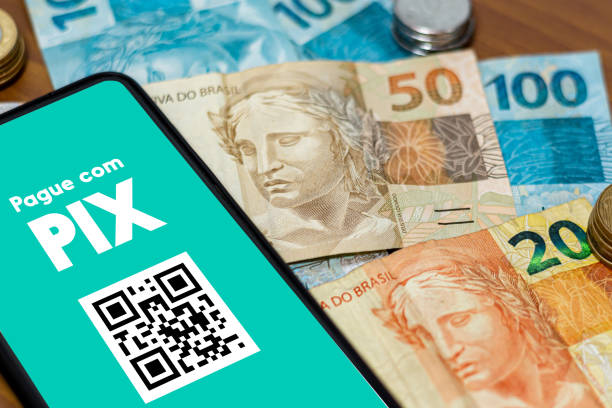 istock Pix on smartphone screen with multiple coins around. Pix is the new payment and transfer system of the Brazilian and Brazilian government. 1432050902