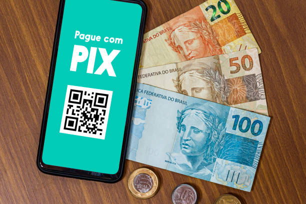 istock Pix on smartphone screen with multiple coins around. Pix is the new payment and transfer system of the Brazilian and Brazilian government. 1432050915